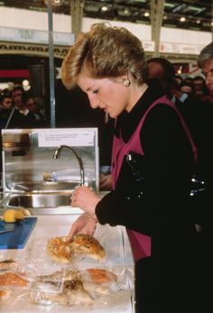 a woman is serving food at an event