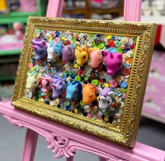 there are many small animals in the frame on this pink chair and it is very colorful