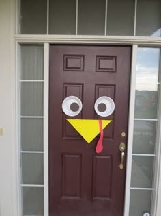 an image of a door decorated to look like a turkey with googly eyes and a nose