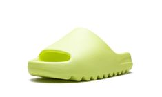 The adidas Yeezy Slide “Glow Green 2022” is a hi-vis colorway of Kanye West’s popular slip-on sandal that was released in full family sizing in May 2022.  The “Glow Green” Yeezy Slide debuted in May 2021 before returning in slightly more quantities in May 2022.  As for its design, the “Glow Green” features a neon green-colored lightweight EVA foam construction that provides optimal comfort.  The midfoot arch stabilizes the foot and the ridged outsole ensures grip on slippery surfaces.  Release d 2022 Shoes, Adidas Shoes Yeezy, Adidas Yeezy Slide, Glow Green, Yeezy Slides, Stadium Goods, The Glow, Eva Foam, Adidas Yeezy