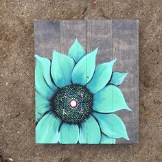 a blue flower painted on wooden planks