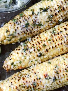 grilled corn on the cob with lime wedges, and sour cream sauce