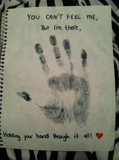 a handprint on a notebook with the words you can't feel me, but i'm there holding your hand through it all