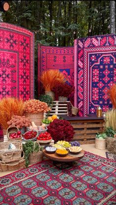 an assortment of colorful rugs and flowers on display