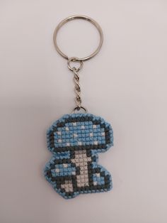 a keychain made to look like an old video game character