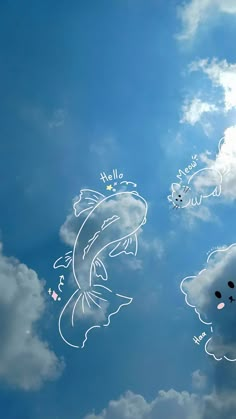 the fish are flying in the sky with some clouds behind them and an animal drawn on it