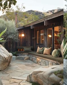 two pictures of the outside of a house with rocks and plants in front of it