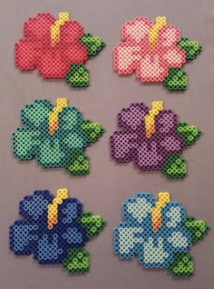 cross stitch flowers are shown in different colors