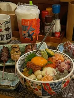 a table topped with bowls filled with different types of meats and veggies