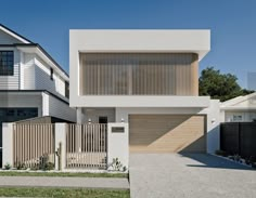 two white houses with wooden slats on the front