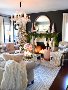 a living room filled with furniture and a fire place covered in christmas tree garlands