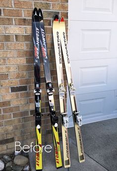 two skis leaning up against a brick wall