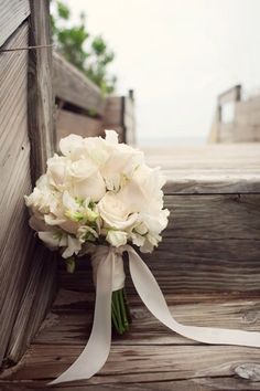 a bouquet of white flowers sitting on the steps