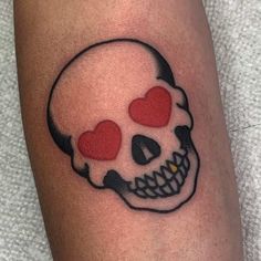 a skull with two hearts on it's face is shown in this tattoo design