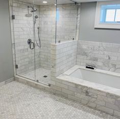 a bathroom with a walk in shower next to a bath tub