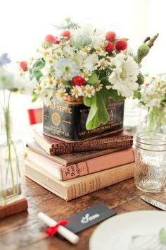 there are flowers in vases and books on the table, along with other decorations