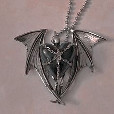 a necklace with a cross on it and a bat hanging from the back of it