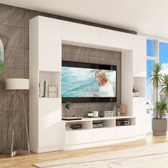 a large flat screen tv mounted to the side of a wall in a living room