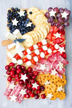 an american flag platter with crackers, grapes, strawberries and pretzels