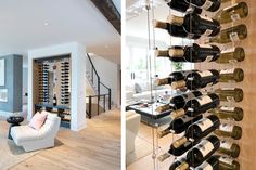 the wine rack in the living room is filled with bottles of wine and sits next to a couch