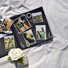 an open notebook with photos and a flower on it