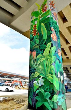 an artisticly painted pillar in the middle of a parking lot