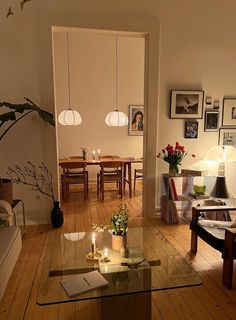 a living room filled with furniture and pictures on the wall