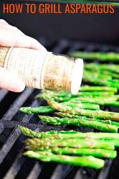 someone is cooking asparagus on the grill