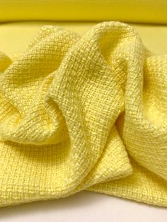 a close up of a yellow cloth on a white surface