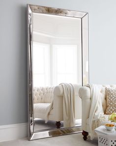 a large mirror sitting on top of a white couch