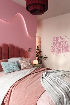 a bedroom with pink walls and bedding in the corner, along with a large headboard