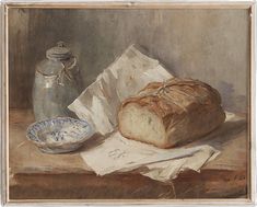 a loaf of bread sitting on top of a table next to a bowl and jar