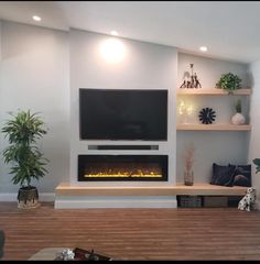 a flat screen tv mounted on a wall above a fire place in a living room