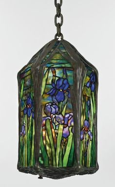 a stained glass light hanging from a chain