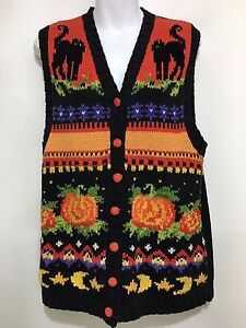 a sweater vest with horses and pumpkins on it