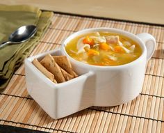 a bowl of soup and crackers on a place mat