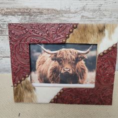 a photo frame with a cow's head on it