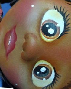 a child's face painted to look like a doll