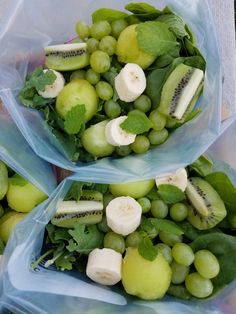 three plastic bags filled with different types of fruit