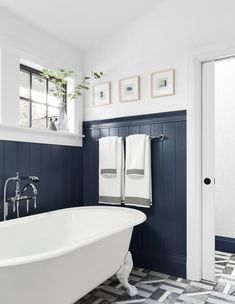 a white bath tub sitting next to a window