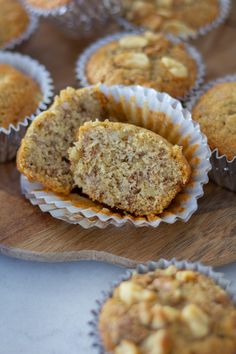 some muffins are sitting on a wooden board