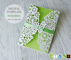 a green and white card with lace on it