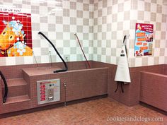 a bathroom with tiled walls and red tile flooring, including an empty bathtub