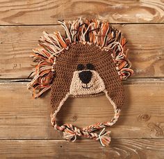 a crocheted hat with a lion's head on it