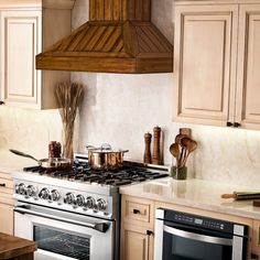 a stove top oven sitting inside of a kitchen next to wooden cabinets and counter tops