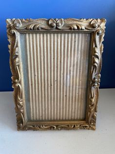 an ornate gold frame on a white table