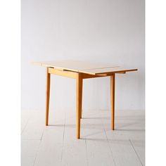 a wooden table sitting on top of a white floor