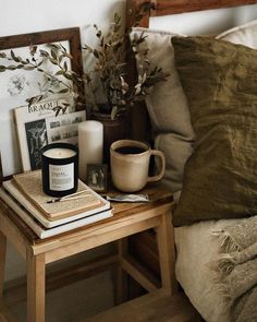 a wooden table topped with books and a candle