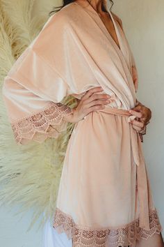 You and your bridal party will love being wrapped up in one of our beautiful robes on your wedding day. Made with a soft, luxurious velvet fabric & intricate lace detailing around the sleeves and bottom edge, our velvet robes are more than comfortable, they are stunningly beautiful & picture perfect. Ideal for giving or receiving as a gift, our robes are buttery soft & stretch to give you all the comfort you need as you lounge, sip mimosas, and get ready on your big day. Each robe is made with f Pink Bridesmaid Dress For Wedding, Pink Lace Bridesmaid Dress, Elegant Blush Wedding Gown, Pink Feminine Bridesmaid Dress For Wedding, Feminine Pink Bridesmaid Dress For Wedding, Champagne Bridesmaid Dress For Wedding, Elegant Spring Bridal Shower Gown, Blush Gown For Weddings, Elegant Peach Wedding Gown