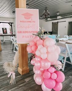 a welcome sign and balloons at a graduation party